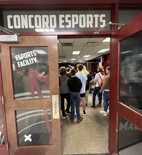 Door frame of room where several students stand
