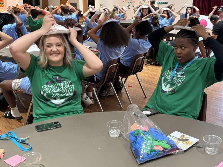 mentors smiling for picture with plate on head