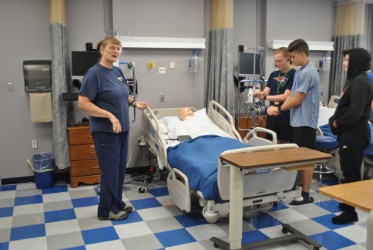 students interacting and listening to a woman