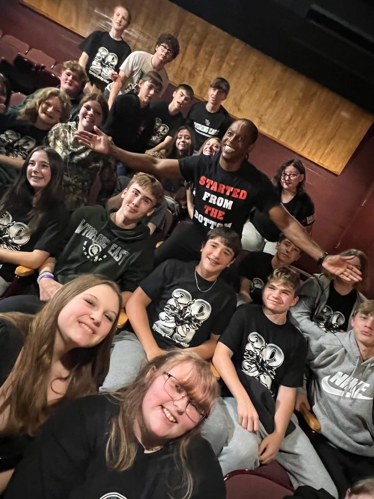 Adolph Brown poses for a picture with students from Wyoming County.
