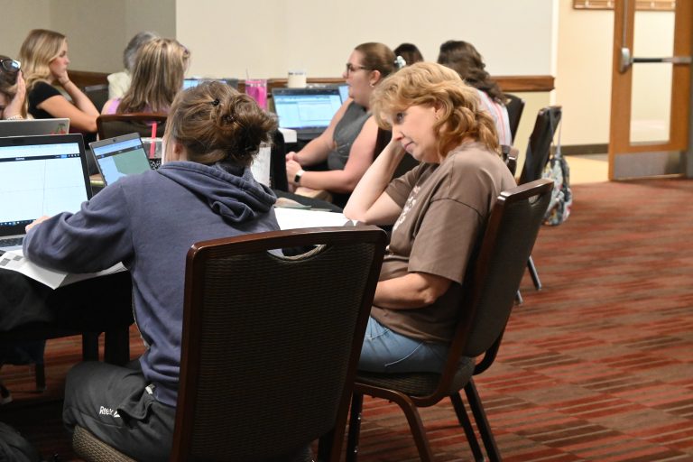 Group of women listen attentively to presentation